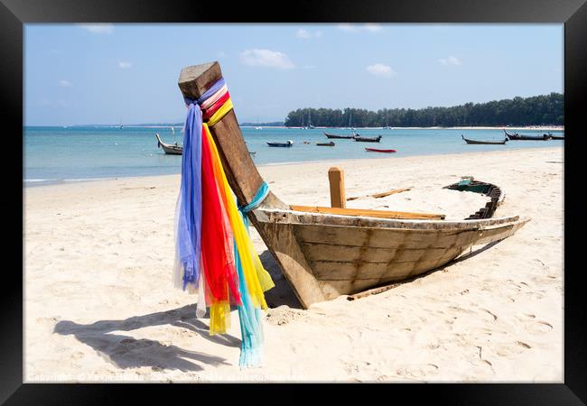 Abandoned long tail boat with colourful ribbons on Framed Print by Kevin Hellon