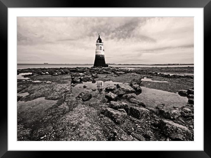 Lighthouse on a rocky shore Framed Mounted Print by David McCulloch