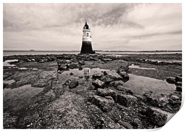 Lighthouse on a rocky shore Print by David McCulloch