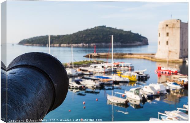Cannon faces out over the harbour Canvas Print by Jason Wells