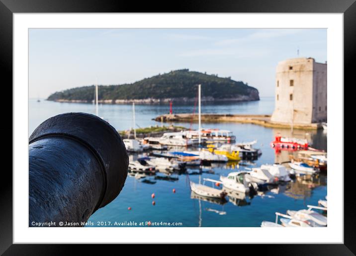 Cannon faces out over the harbour Framed Mounted Print by Jason Wells