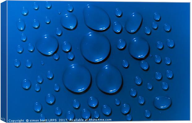 Water drops pattern on blue background Canvas Print by Simon Bratt LRPS