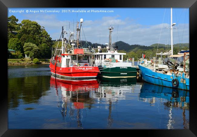 Fishing boat reflections Strahan harbour Tasmania Framed Print by Angus McComiskey