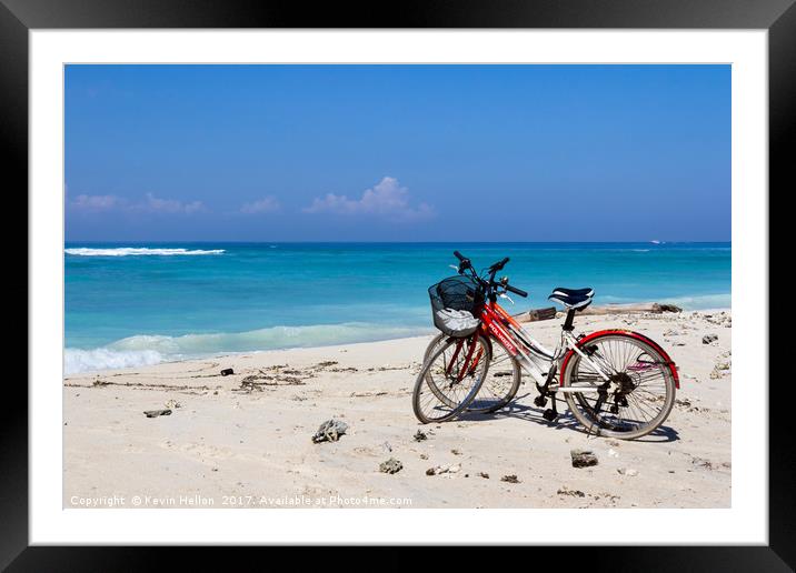 Bicycles on a white sand beach Framed Mounted Print by Kevin Hellon