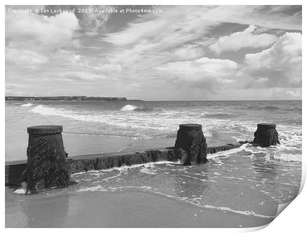 Exmouth over the sea defences at Dawlish Warren Print by Ian Lockwood