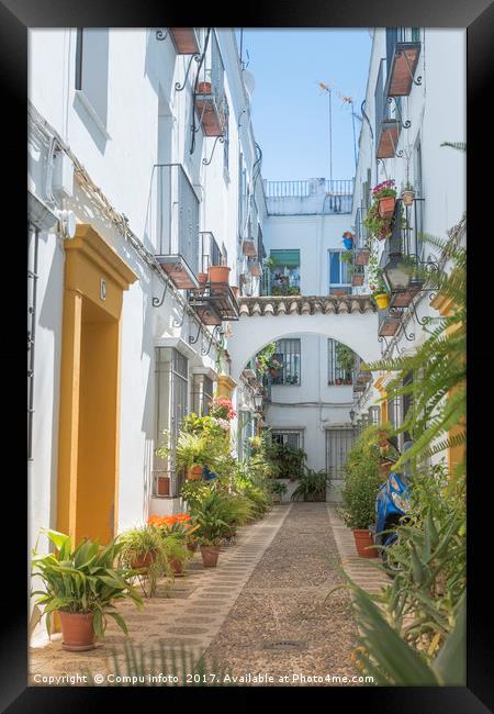 small spanish street with flowers  Framed Print by Chris Willemsen