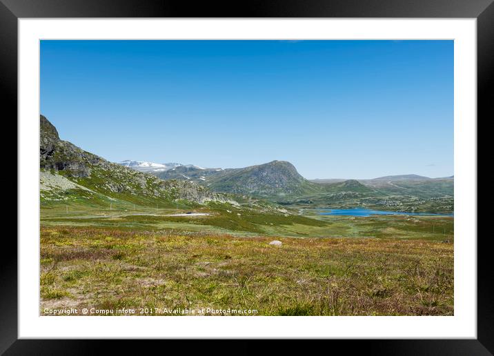 mountains in norway with blue sky background Framed Mounted Print by Chris Willemsen