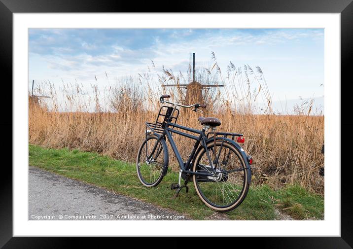 old type of bike and windmill Framed Mounted Print by Chris Willemsen
