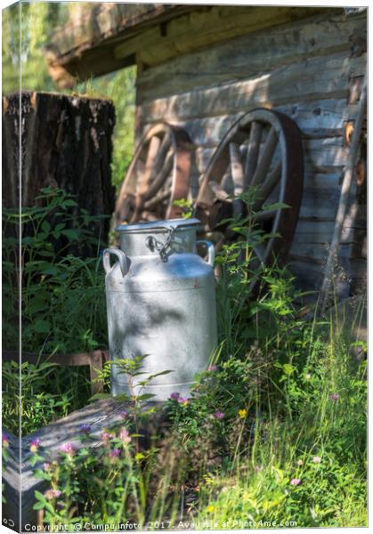 old milk chirn in front of old house Canvas Print by Chris Willemsen