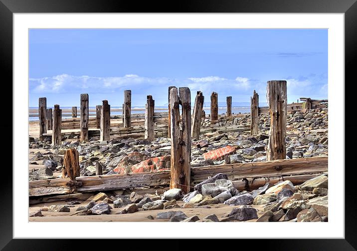 Battered Remains of Groynes along the beach Framed Mounted Print by Mike Gorton