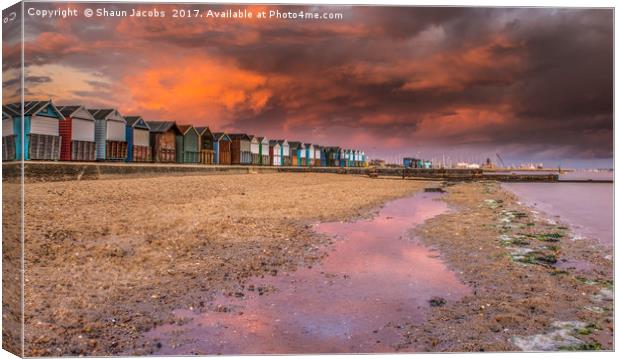 Beach hut sunset in Poole.  Canvas Print by Shaun Jacobs
