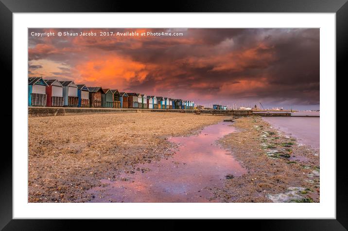 Beach hut sunset in Poole.  Framed Mounted Print by Shaun Jacobs