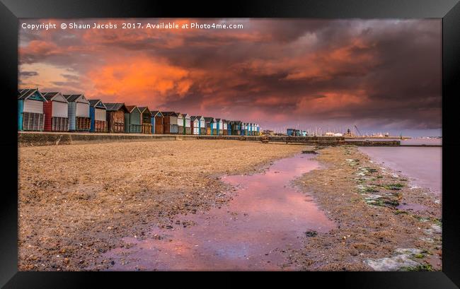 Beach hut sunset in Poole.  Framed Print by Shaun Jacobs