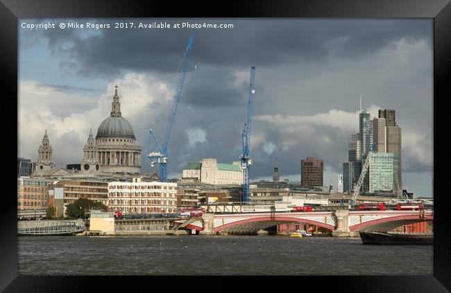 Stormy skies over the city of London Framed Print by Mike Rogers
