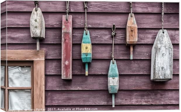 Fishing floats hanging on a wooden wall Canvas Print by Gary Parker