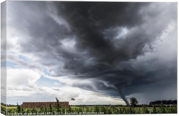 Storm tornado or twister lifting hay bales in stor Canvas Print by Simon Bratt LRPS