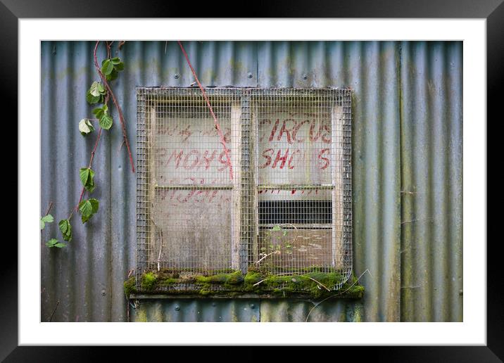 Old circus poster in barn window. Framed Mounted Print by Bryn Morgan