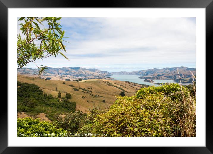 View across rolling hills to the natural harbour o Framed Mounted Print by Kevin Hellon