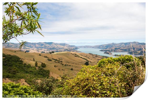 View across rolling hills to the natural harbour o Print by Kevin Hellon