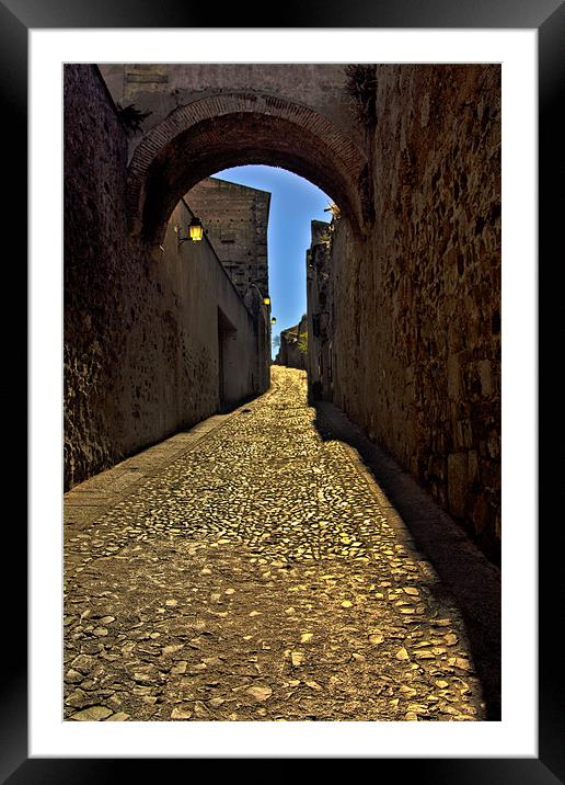 Old arch over narrow street in Caceres Framed Mounted Print by Gabor Pozsgai