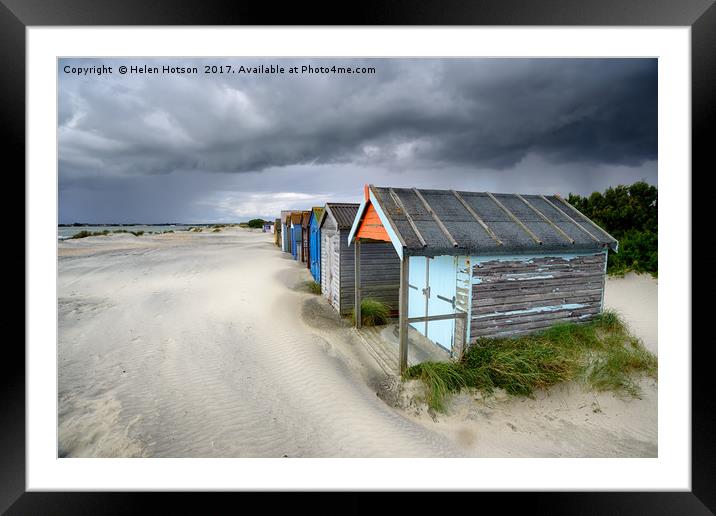 Beach Huts Under A Stormy Sky Framed Mounted Print by Helen Hotson
