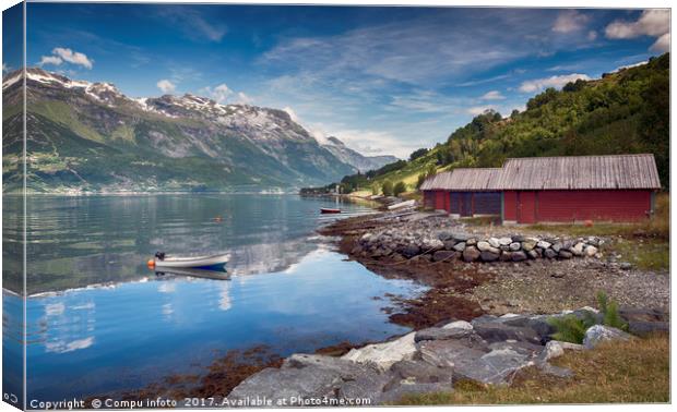 red houses and a boat in the fjord in norway Canvas Print by Chris Willemsen