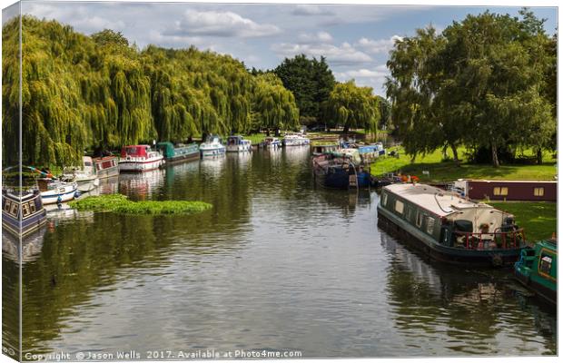 Boats line the river side of the River Great Ouse Canvas Print by Jason Wells