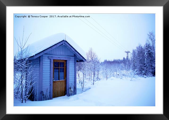 A Blue Wooden Cabin on a Carpet of Fresh Snow  Framed Mounted Print by Teresa Cooper