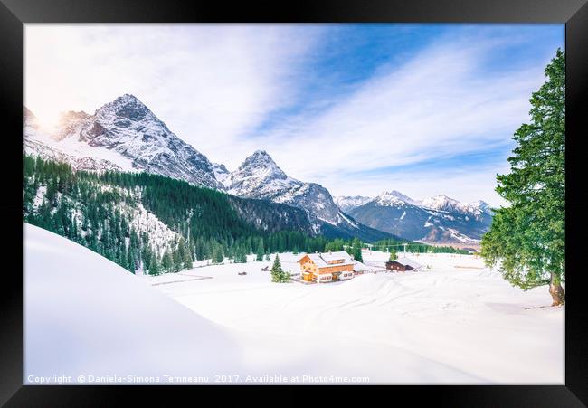 Alpine village in winter decor Framed Print by Daniela Simona Temneanu