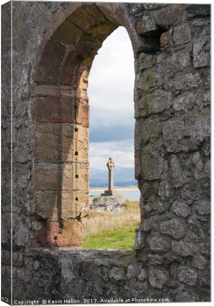 Celtic cross and remains of St Dynwen's church, Ll Canvas Print by Kevin Hellon