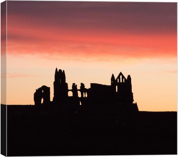 Sunrise behind Whitby Abbey  Canvas Print by Janet Mann