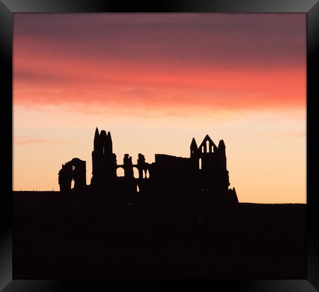 Sunrise behind Whitby Abbey  Framed Print by Janet Mann