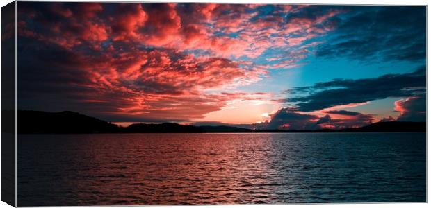 Crimson Sunrise Seascape with Water Reflections. Canvas Print by Geoff Childs