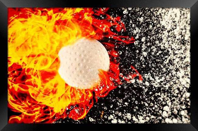 Golf ball between fire and water Framed Print by Guido Parmiggiani