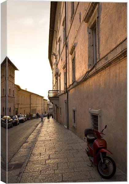 Moped in street at sundown in Assisi, Italy Canvas Print by Ian Middleton