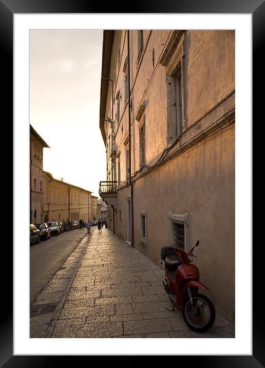 Moped in street at sundown in Assisi, Italy Framed Mounted Print by Ian Middleton