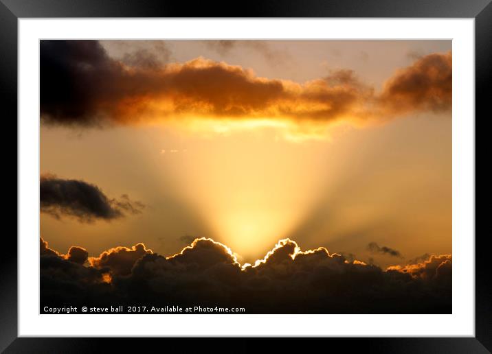 Sun rays and dark clouds Framed Mounted Print by steve ball