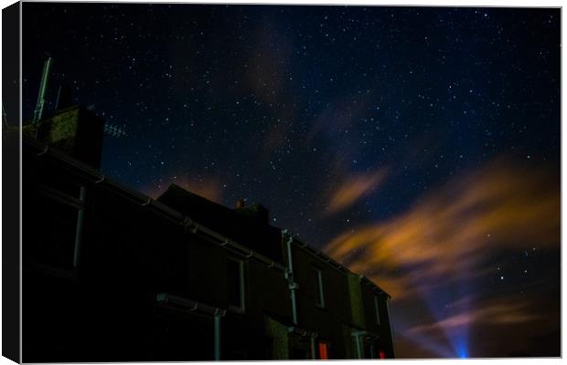 The stars above the houses Canvas Print by Kieran Bellis
