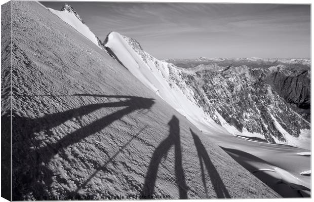 Shadows of three climbers in the Swiss Alps Canvas Print by Colin Woods