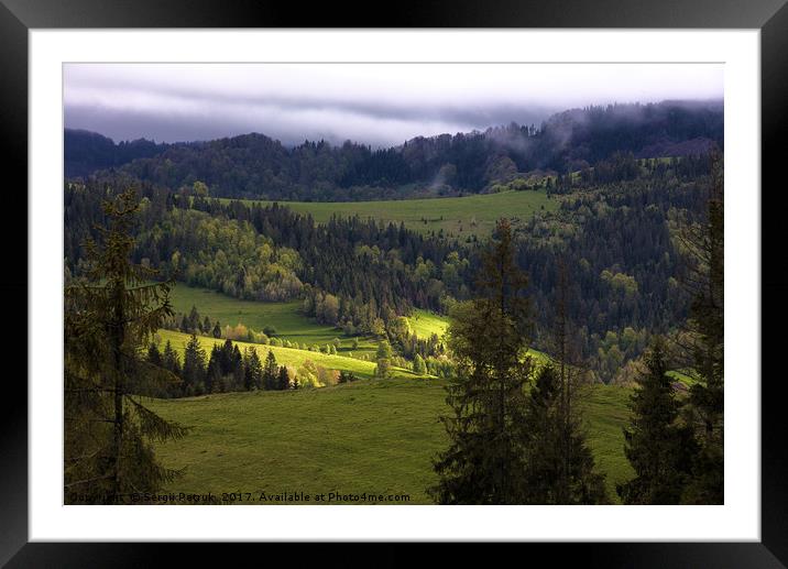 A sunbeam illuminates a valley in the mountains Framed Mounted Print by Sergii Petruk