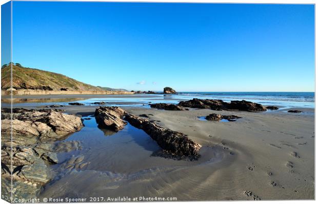 Millendreath Beach and Black Rock at low tide Canvas Print by Rosie Spooner