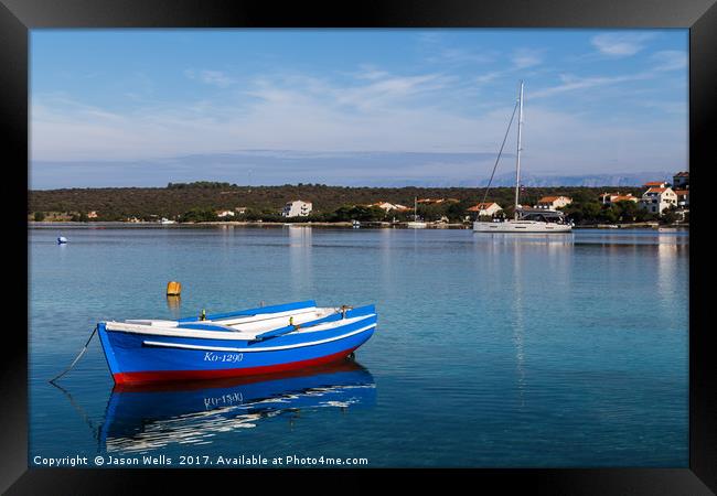 Reflections of a boat in Loviste Bay Framed Print by Jason Wells