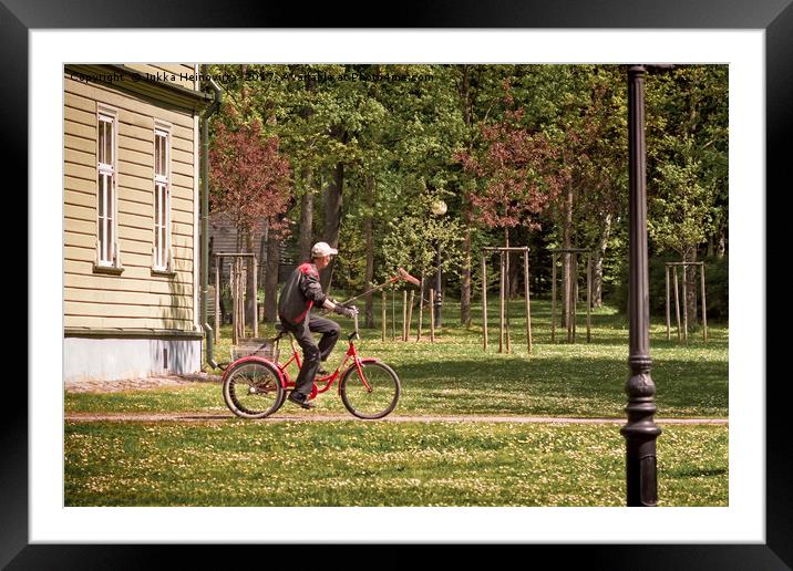 Park Worker Riding a Bike with a Rake Framed Mounted Print by Jukka Heinovirta