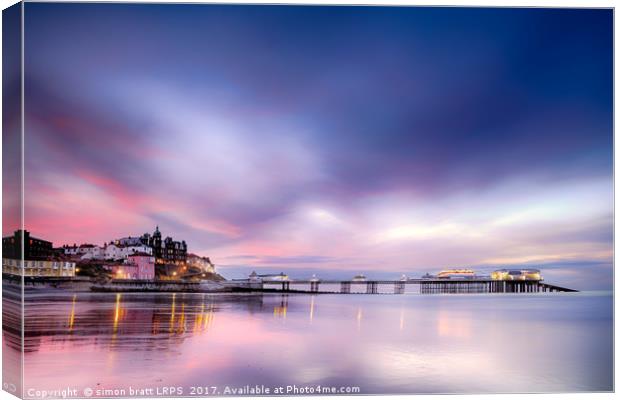 Famous Cromer pier in Norfolk England with pink su Canvas Print by Simon Bratt LRPS