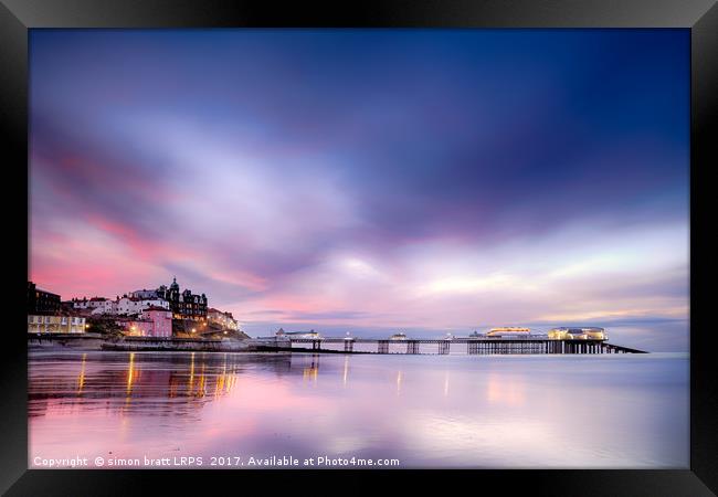 Famous Cromer pier in Norfolk England with pink su Framed Print by Simon Bratt LRPS