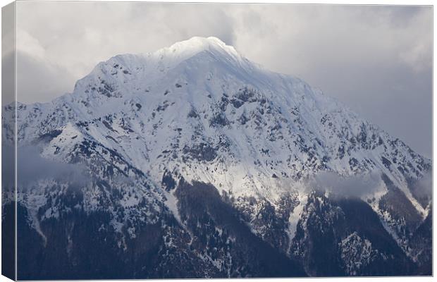 Snowy Alpine peak Canvas Print by Ian Middleton