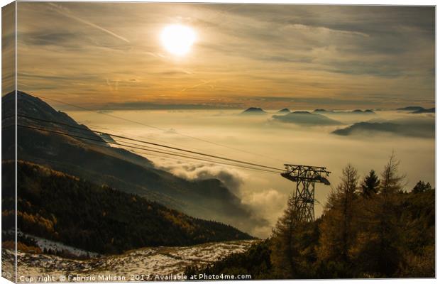 The sun sets over a sea of clouds Canvas Print by Fabrizio Malisan