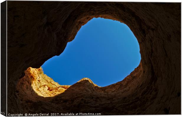 Blue sky thru cliff opening Canvas Print by Angelo DeVal