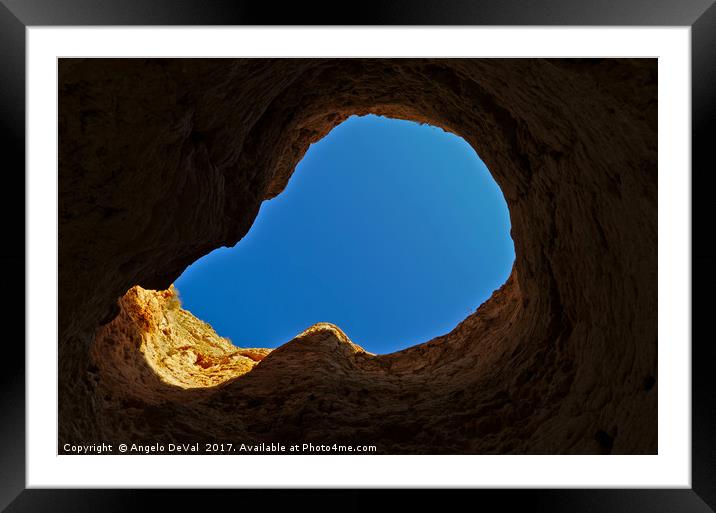 Blue sky thru cliff opening Framed Mounted Print by Angelo DeVal