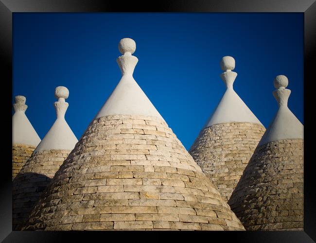 Trulli roofs Framed Print by Roger Warham